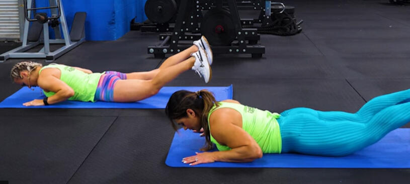 Fitness athletes performing specialized glute activation floor exercises to isolate muscles and improve symmetry.